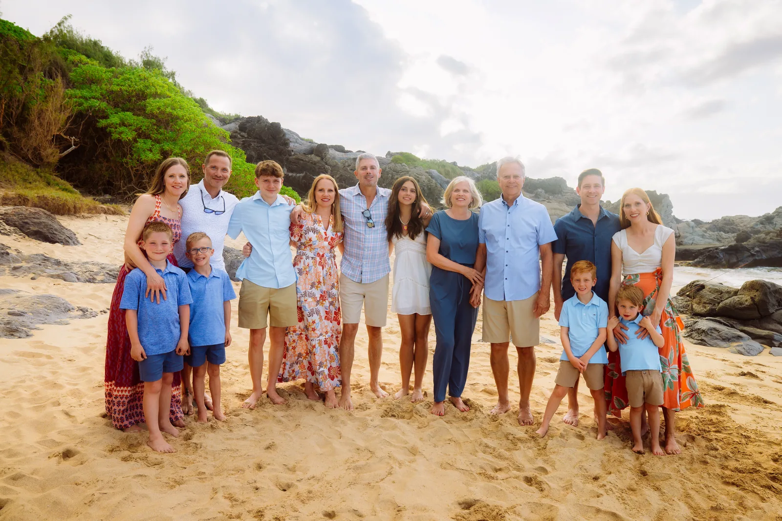 A large extended family photographed together on the sand