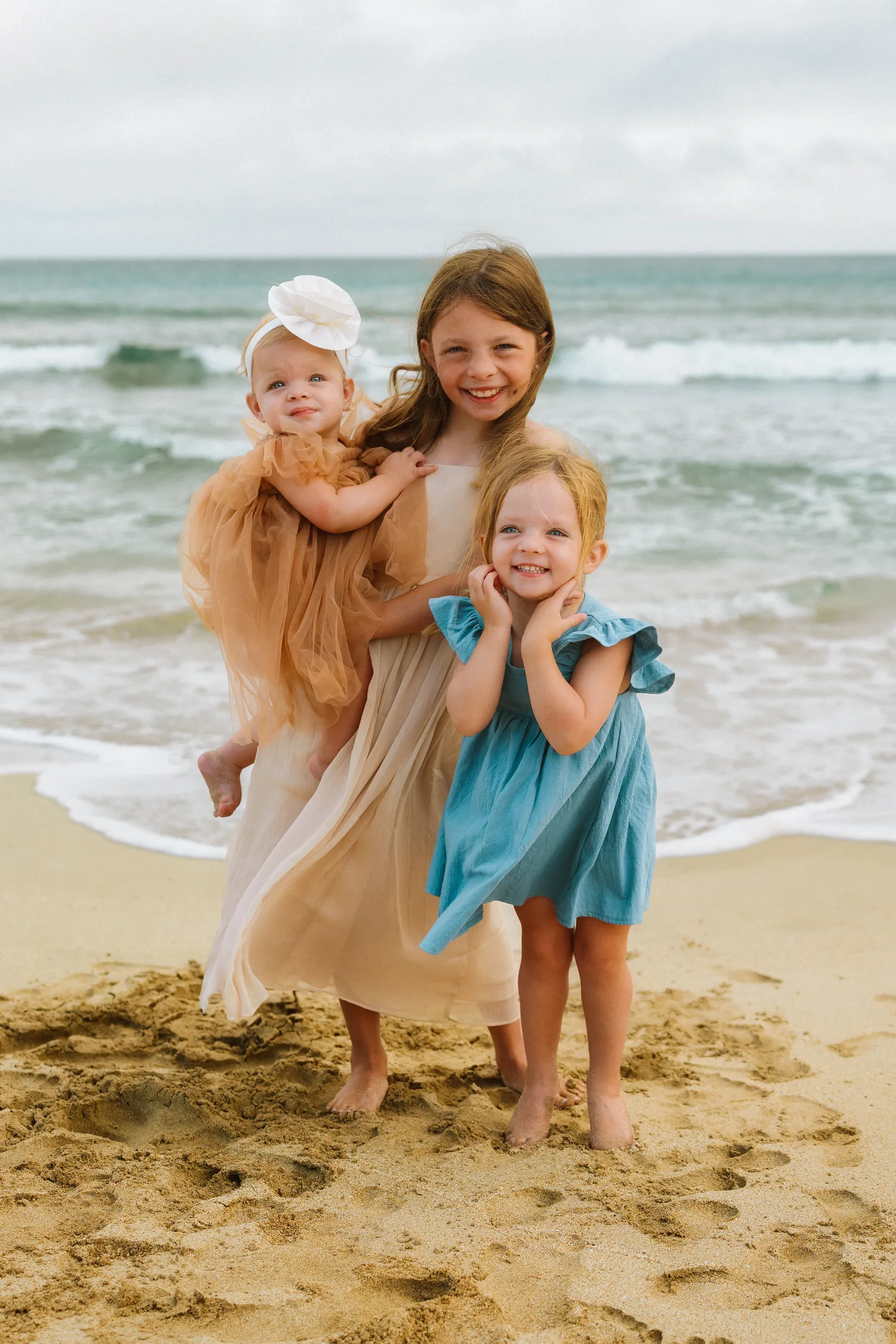 Sisters laughing together at the water's edge