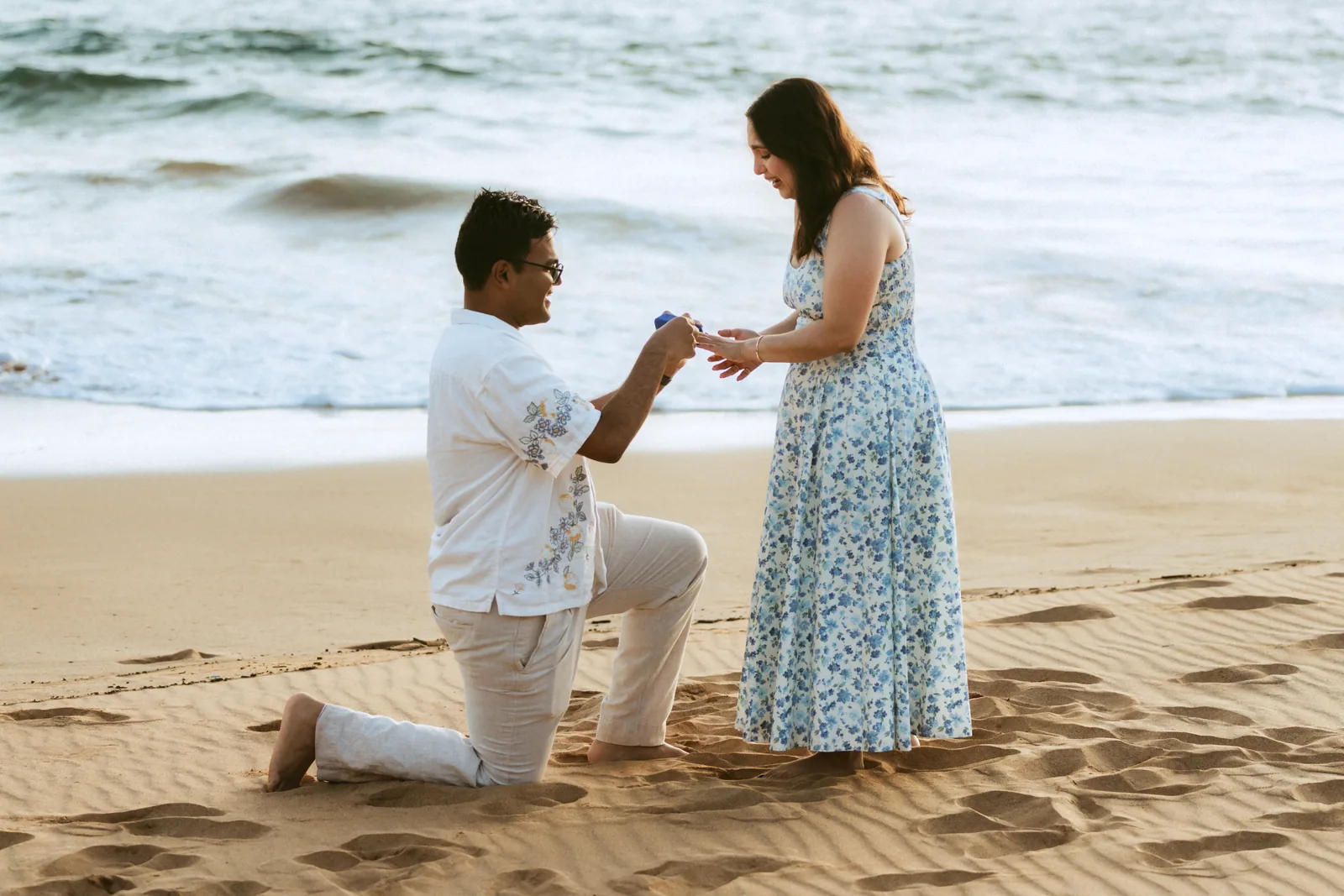 A proposal on the open sand as the light goes gold