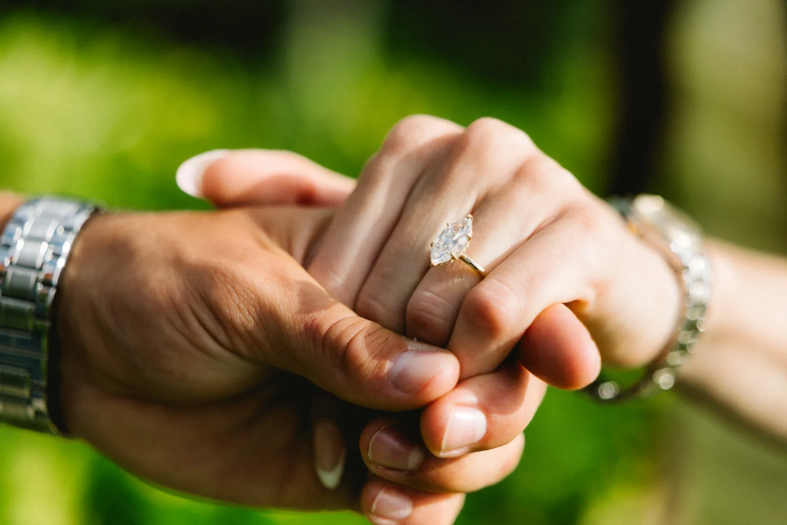 A close detail of the engagement ring on her finger